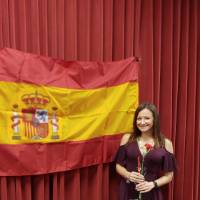 Riley Burgess posing in front of Spanish flag